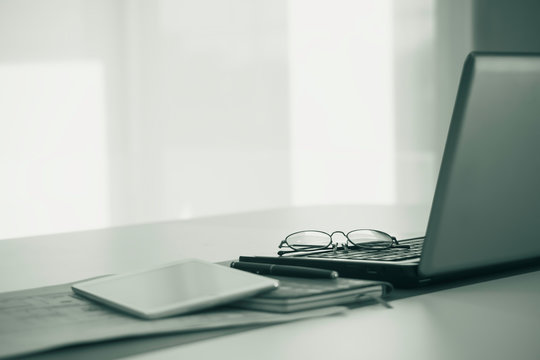 Work From Home, A Glasses Above Laptop Computer On A White Modern Business Office Desk Tabl