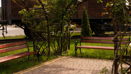 
Benches with decorative vegetation by the old wagon