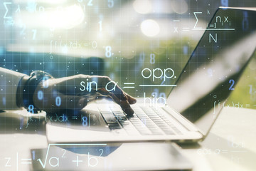 Creative scientific formula concept with hands typing on laptop on background. Multiexposure