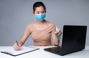 Fototapeta na wymiar Asia woman working from home during coronavirus outbreak