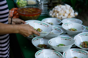 close up hand holding a bowl while preparing for food