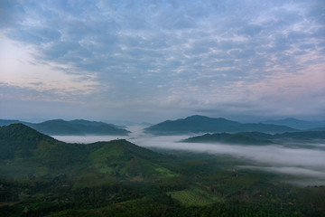 Obraz na płótnie Canvas Scenery of mountains under mist in the morning in Thailand.