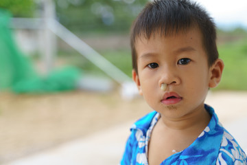 Asian boy in local suit with blocked stuffy nose from flu or cold disease
