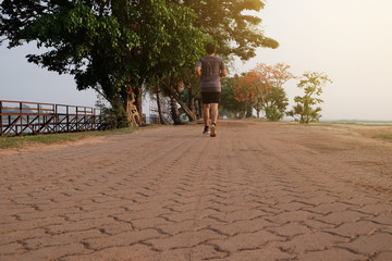 Fototapeta premium Asian male runner is stretching on the street before doing work out in the morning