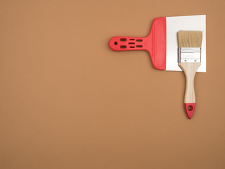 Construction tools on a beige background. Brush and spatula.