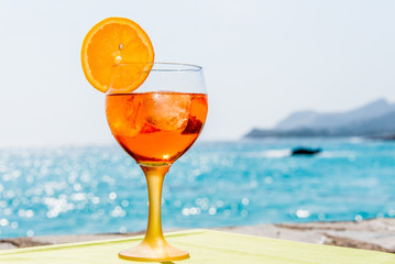 Glass of vermouth in front of the sea