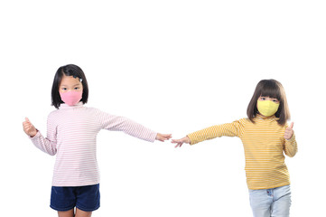 Social distance concept. Two Asian kids showing thumbs up gesture ,wearing mask standing distance of 2 meter from other people keep distance protect from COVID-19 and The risk of infection to others.