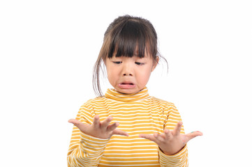 Baby health care for germs and touch concepts. A little Asian girl (5years old) shocking by bacteria on hands. Kid in yellow t-shirt with emotion face and The gestures raised both hands near face.