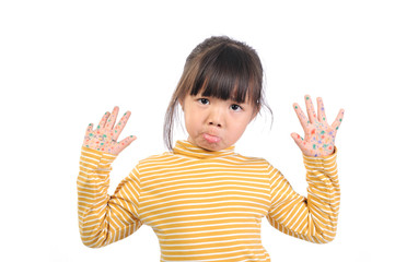 Baby health care for germs and touch concepts. A little Asian girl (5years old) shocking by bacteria on hands. Kid in yellow t-shirt with emotion face and The gestures raised both hands near face.