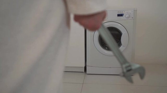 A young woman standing in front washing machine