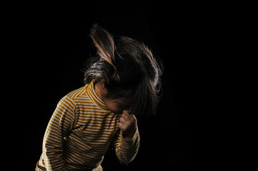 Kid of sneezing, coughing, shocking food concept. A little Asian girl of 5 years old covered nose while sneezing and Causing the water to flow out of the mouth with black background.