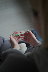 Sick woman holds a thermometer