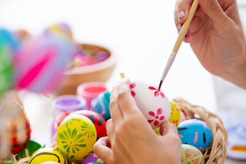 Fototapeta na wymiar Girl enjoy painting a water colors on fantasy eggs for Easter egg festival.