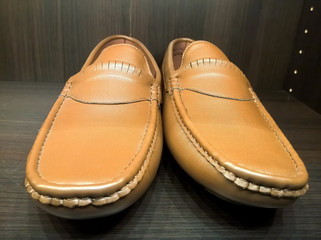 Men leather shoes on the shelf in the store. Brown men's shoes on the stand. Male style, fashion. Gathering the groom. 