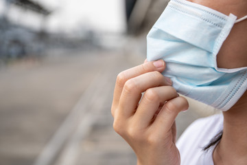 Asian woman wearing a hygiene protective mask to protect her self from coronavirus disease, Covid-19 or 2019-nCoV world critical pandemic crisis awareness. Covid19 pandemic disaster in 2019 and 2020.