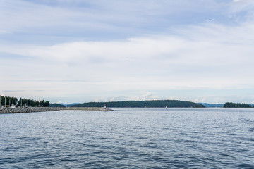 Naklejka na ściany i meble Haro strait view from Vancouver island with cloudy sky British Columbia Canada.