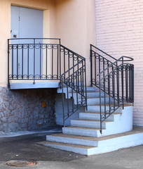 Entrance to the building, concrete porch with metal railings