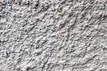 The surface of the fence is created by throwing cement and painted white.
