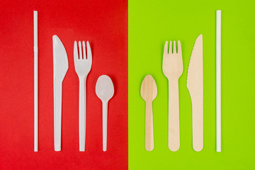 Plastic cutlery on red background and eco friendly disposable cutlery on green background. Bamboo wooden fork, knife, spoon and paper straw. Zero waste concept