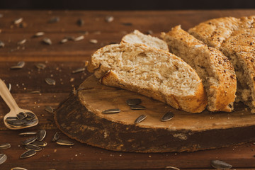 Freshly baked wholemeal bread on wooden board with sunflower seeds