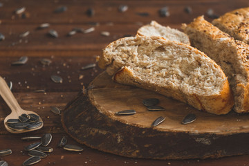 Freshly baked wholemeal bread on wooden board with sunflower seeds