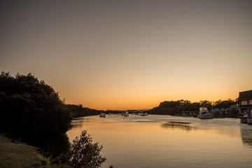 dawn on the river with boats