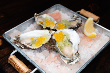 Raw oyster with lemon and salmon egg