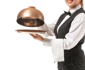 Beautiful female waiter with tray and cloche on white background