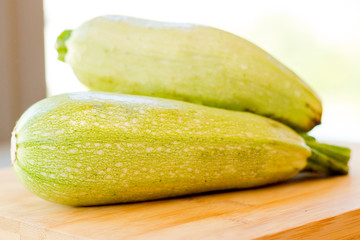 Fresh zucchini on wooden background