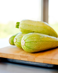 Fresh zucchini on wooden background