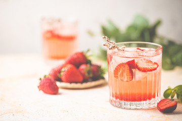Refreshing summer drink with strawberry slices in glasses on white background
