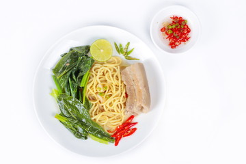 Ramen topped Chinese kale and streamed streaky pork in soup with halve green lemon and sliced chili and minced chili .