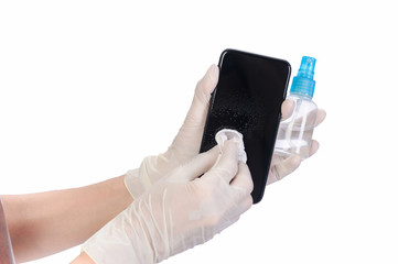 Health care and protection Bacteria through touch concept. Close up women's hands wear rubber gloves, using alcohol spray to wipe clean a mobile phone to prevent viruses or germs on isolate of white.
