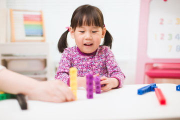 toddler girl play number blocks for homeschooling