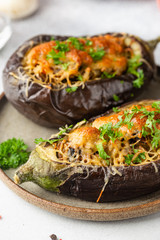 Baked aubergine or eggplant boats stuffed with mushrooms, vegetables and cheese
