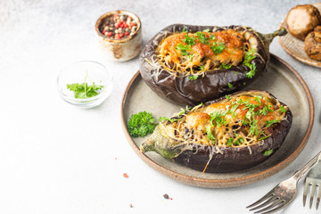 Baked aubergine or eggplant boats stuffed with mushrooms, vegetables and cheese