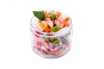 Olivier salad with shrimp in a jar on a white background
