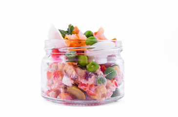 Olivier salad with shrimp in a jar on a white background