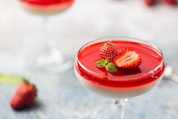Italian panna cotta dessert with strawberry sirup and mint leaf