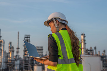 White woman engineer, logistics and transportation business of gas and oil with background of oil and gas refinery, import, export and transportation in the industry