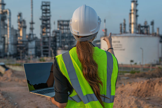 White woman engineer, logistics and transportation business of gas and oil with background of oil and gas refinery, import, export and transportation in the industry - Powered by Adobe