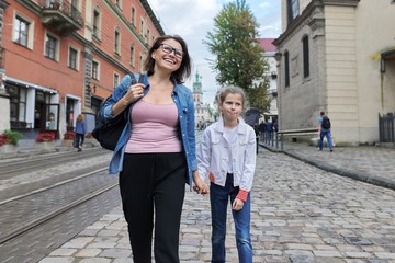 Mother and daughter child 8, 9 years old walking together