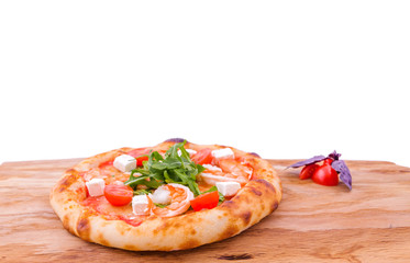 Pizza with prawns, tomatoes, arugula and cheese on a wooden tray. The object is isolated on a white background. Horizontal photo