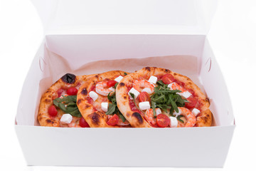 Pizza in a cardboard box, isolated on white
