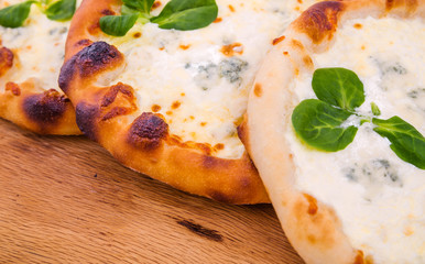 Three delicious fresh pizzas with cream on wood background