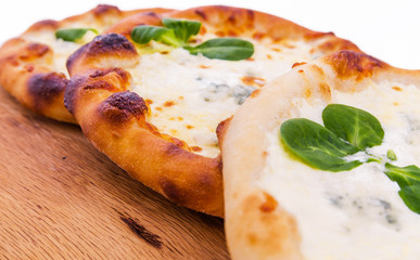 Three delicious fresh pizzas with cream on wood background