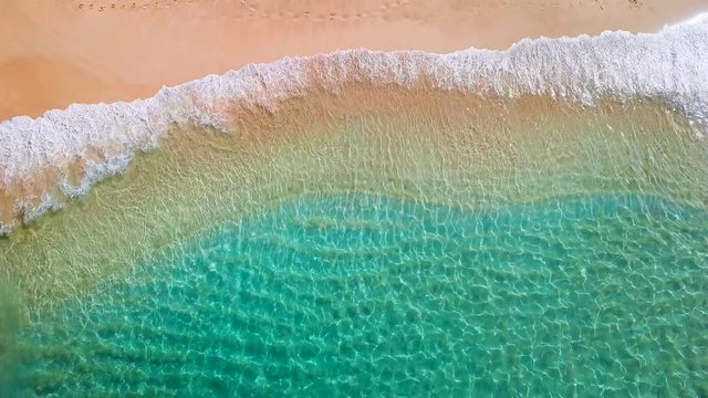 Tropical beach on Oahu island in Hawaii. Top down view of the perfect sandy beach with gentle rolling waves