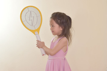 A child with a yellow mosquito swatter