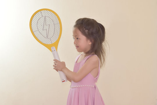 A Child With A Yellow Mosquito Swatter