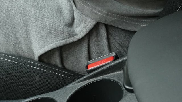 Fastening three-point seat belt in car 4K video
